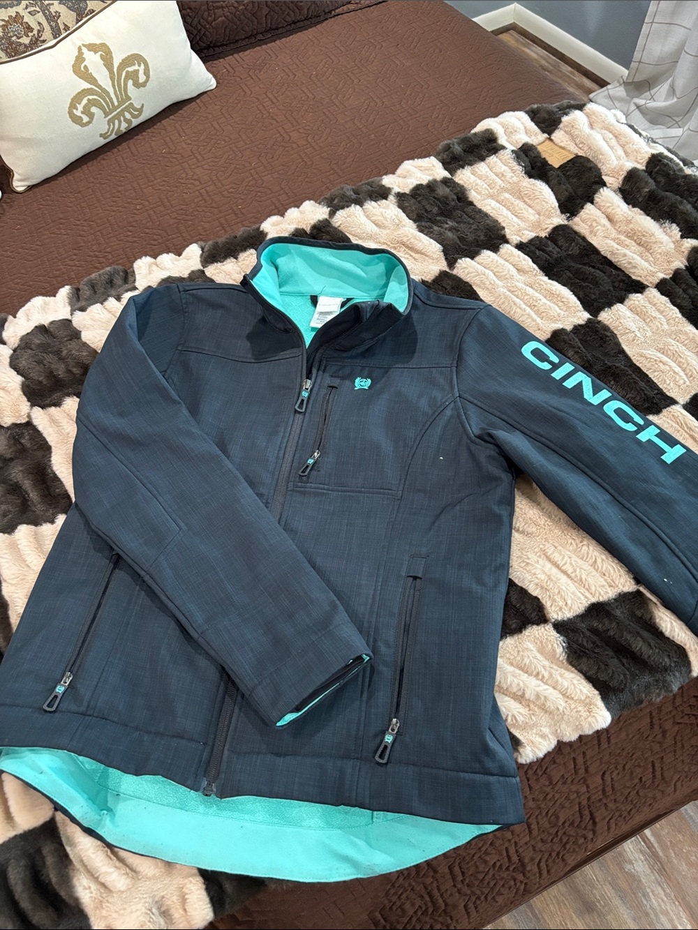 Cinch Black Jacket with Teal Branding and Lining